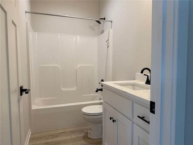 full bathroom featuring hardwood / wood-style flooring, vanity, toilet, and tub / shower combination