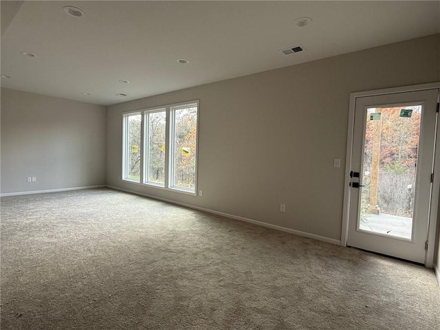 unfurnished room with light colored carpet