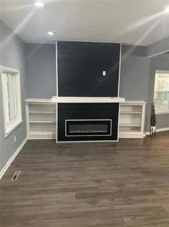 unfurnished living room with dark hardwood / wood-style floors