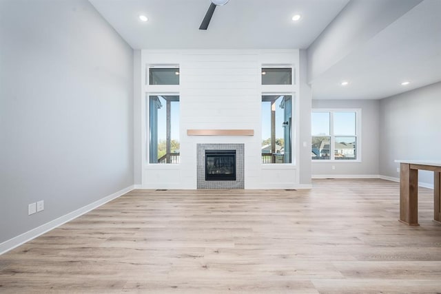 unfurnished living room featuring light hardwood / wood-style flooring and ceiling fan