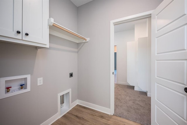 laundry room featuring hookup for a washing machine, cabinets, hookup for an electric dryer, and hardwood / wood-style floors