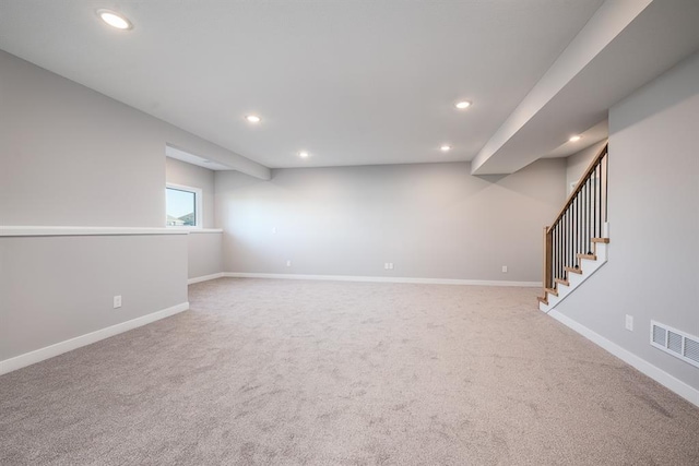 basement featuring light colored carpet