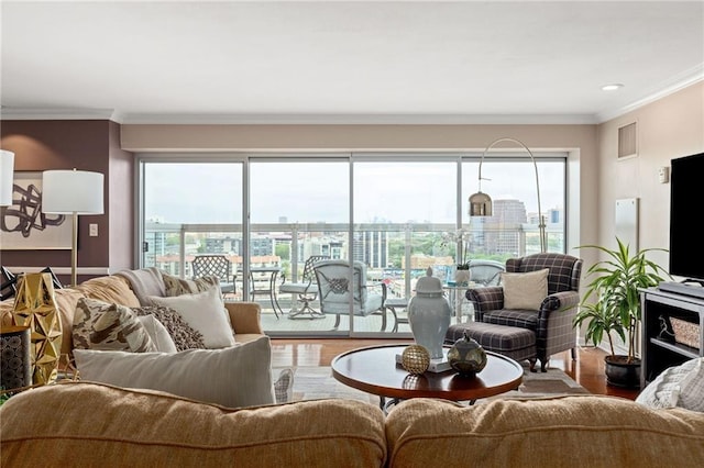 living room with hardwood / wood-style floors and crown molding