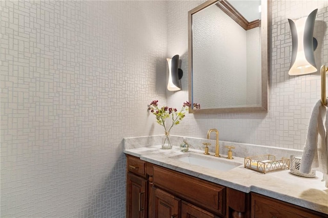 bathroom featuring vanity, ornamental molding, and tile walls