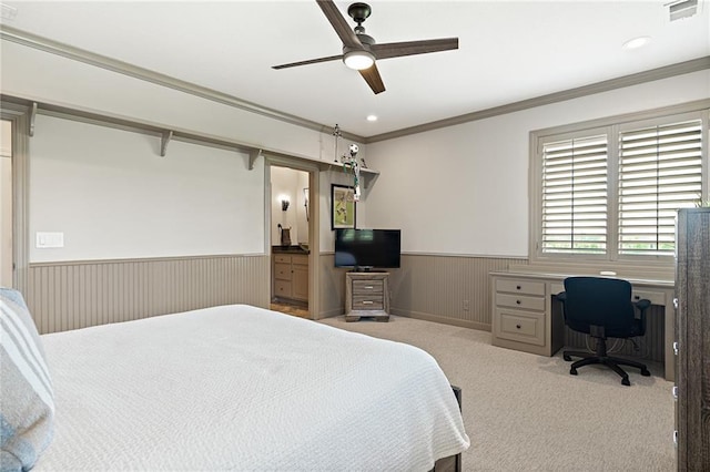 bedroom with ornamental molding, visible vents, ceiling fan, a wainscoted wall, and light carpet