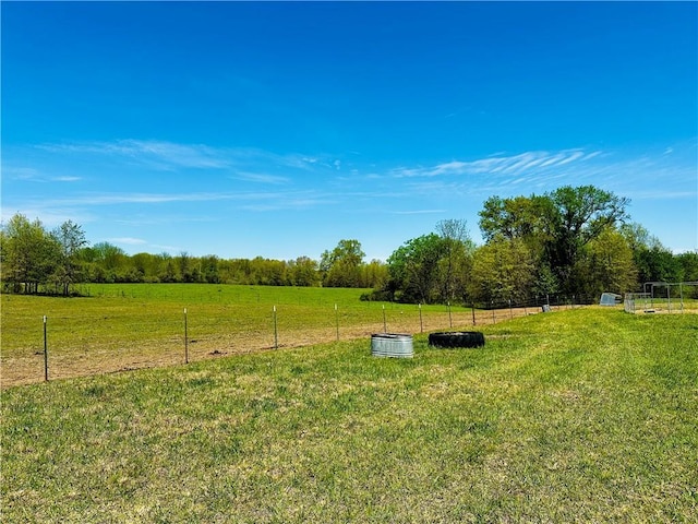 view of yard featuring a rural view and fence