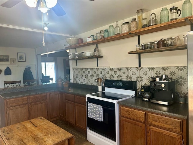 kitchen featuring open shelves, dark countertops, a peninsula, and electric stove