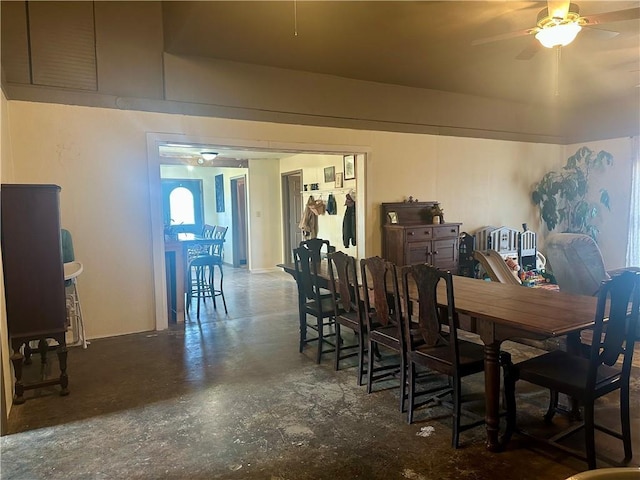 dining room featuring ceiling fan and finished concrete floors