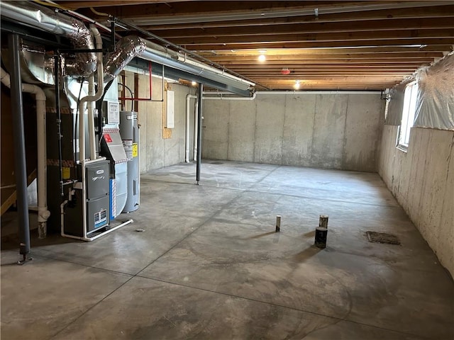 basement with water heater and heating unit