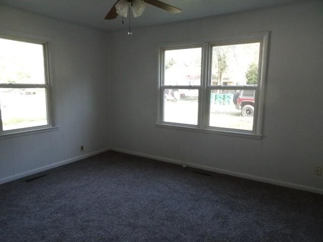 spare room with ceiling fan, carpet floors, and a healthy amount of sunlight