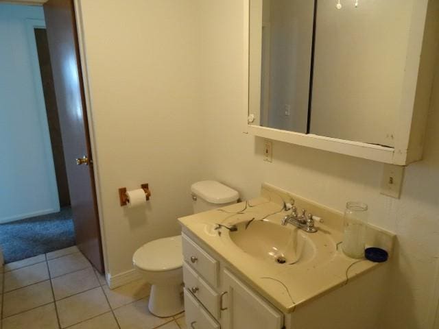 bathroom with tile patterned flooring, vanity, and toilet