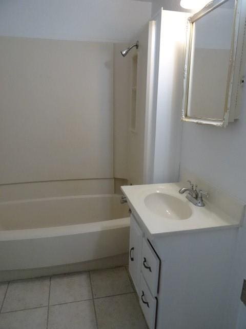 bathroom with vanity, shower / bathtub combination, and tile patterned floors