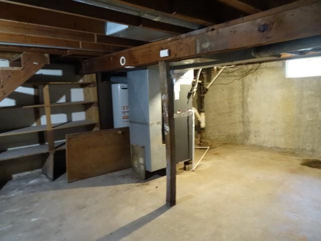 basement featuring gas water heater and heating unit