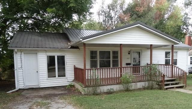 exterior space featuring a lawn and covered porch