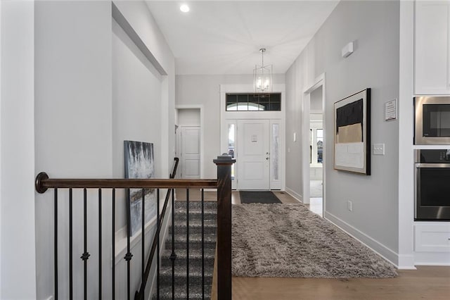 entryway with a chandelier and wood-type flooring