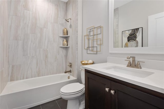 full bathroom featuring tiled shower / bath, vanity, toilet, and tile patterned flooring