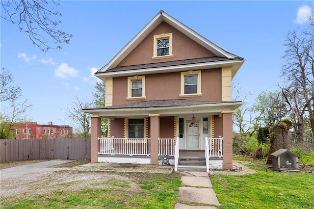 view of front facade with a front lawn and covered porch