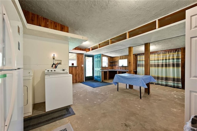 interior space with white fridge and washing machine and dryer