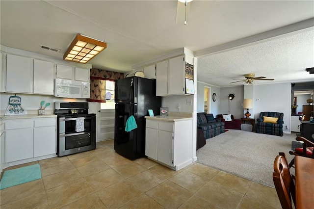 kitchen with ceiling fan, light tile floors, electric stove, white cabinetry, and black fridge