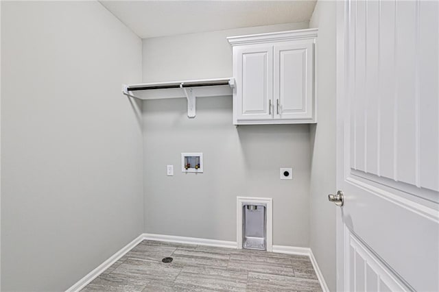 laundry room with cabinets, washer hookup, light wood-type flooring, and hookup for an electric dryer