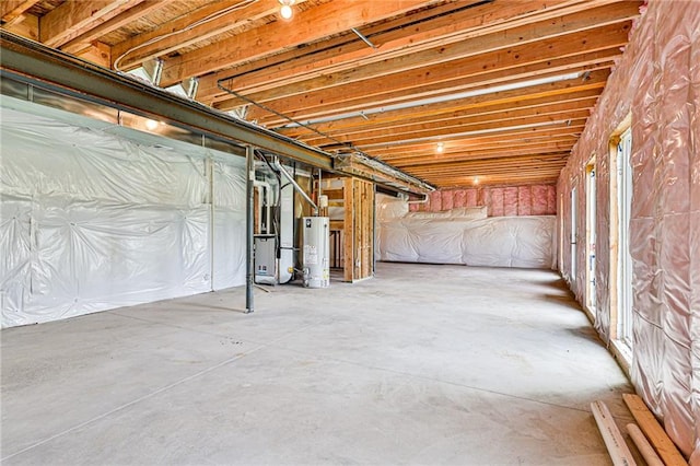 basement featuring heating unit and water heater