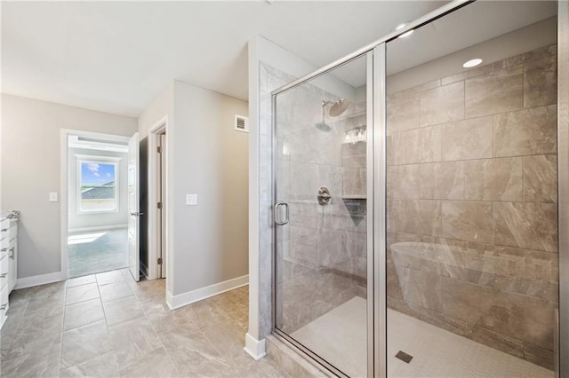 bathroom with vanity and a shower with shower door