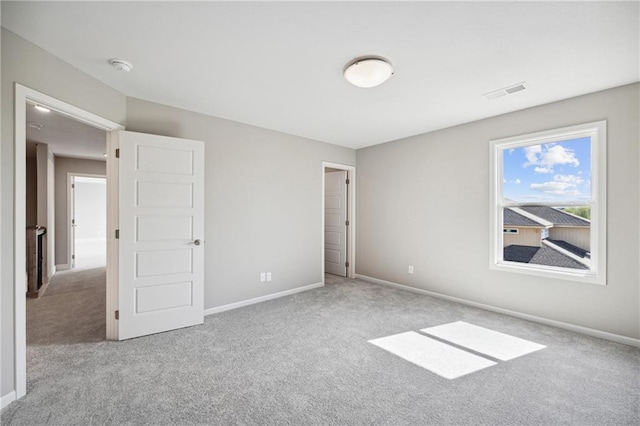 unfurnished bedroom featuring light carpet