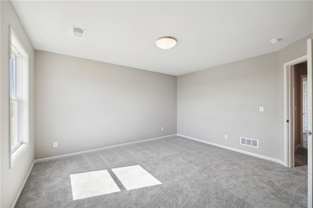 unfurnished room with light colored carpet