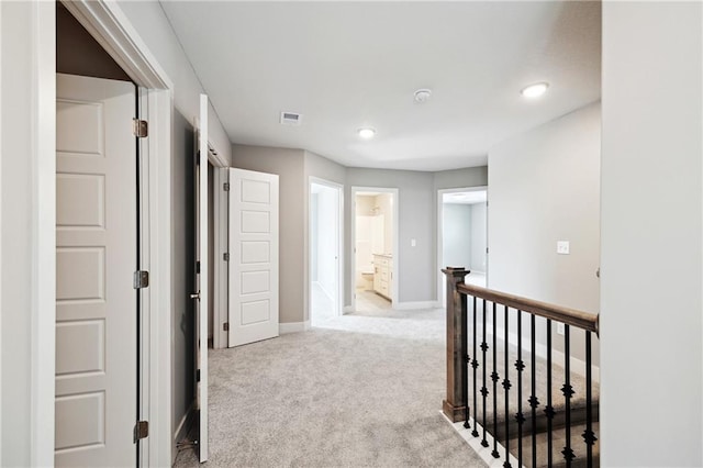 hallway featuring light carpet