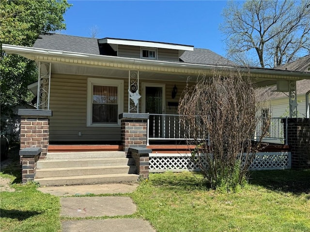 bungalow featuring a porch and a front yard