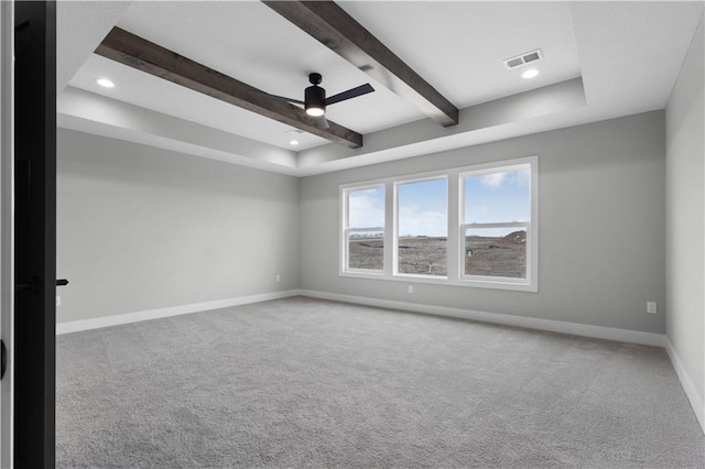 unfurnished room with beam ceiling, ceiling fan, and carpet