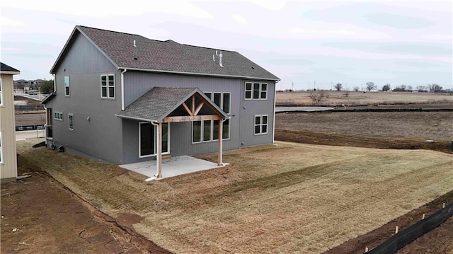 back of property with a patio area and a lawn