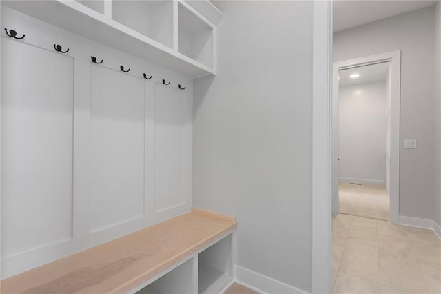 mudroom with light tile patterned floors and baseboards