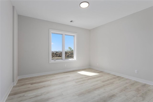 empty room featuring light wood-style floors and baseboards