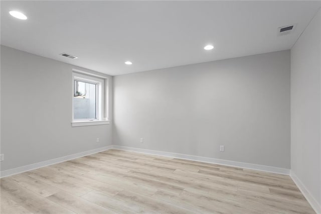 empty room with recessed lighting, visible vents, light wood-style flooring, and baseboards