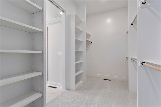 walk in closet with carpet floors and visible vents