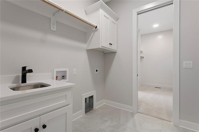 laundry area with baseboards, a sink, cabinet space, and hookup for an electric dryer