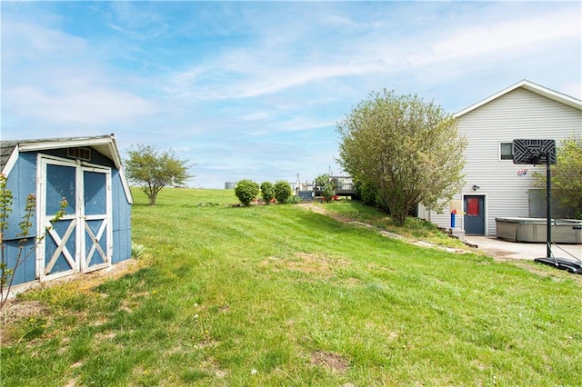 view of yard with a storage shed and a hot tub