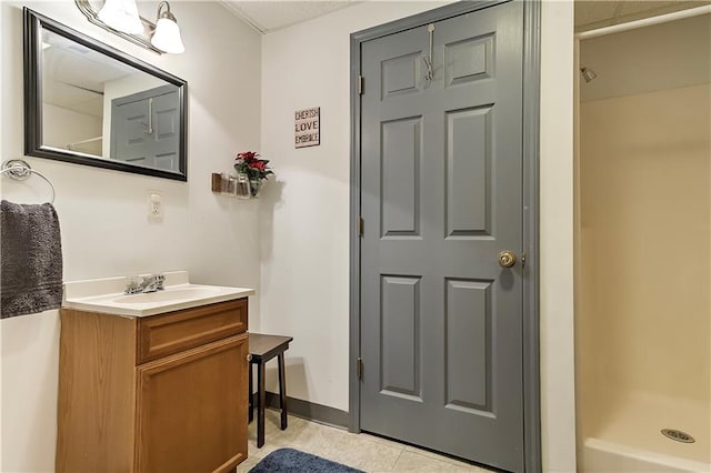 bathroom featuring a shower, tile patterned flooring, and vanity