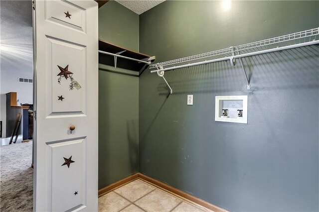 walk in closet featuring tile patterned flooring