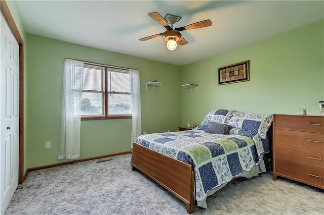 carpeted bedroom featuring ceiling fan and a closet