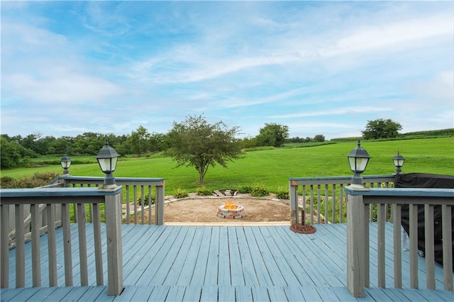 wooden terrace with a yard and an outdoor fire pit