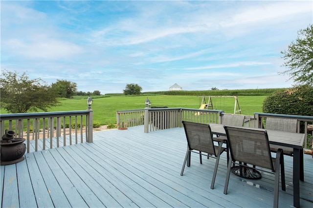 wooden terrace with a lawn and a rural view