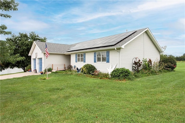 ranch-style home with a front yard and solar panels