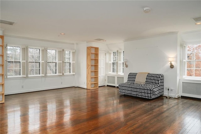 living area with dark wood-type flooring, radiator heating unit, and crown molding