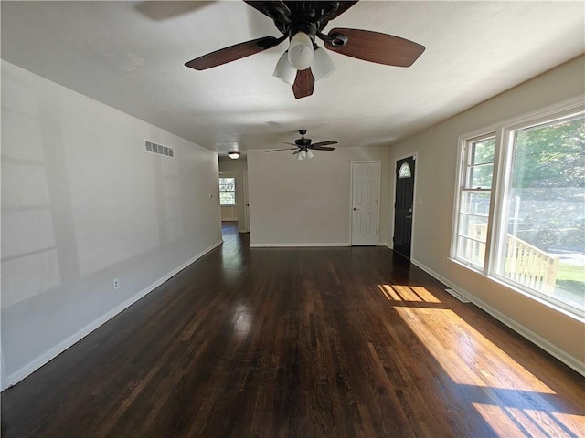 unfurnished room with dark wood-type flooring