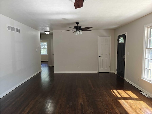 spare room with ceiling fan and dark hardwood / wood-style flooring