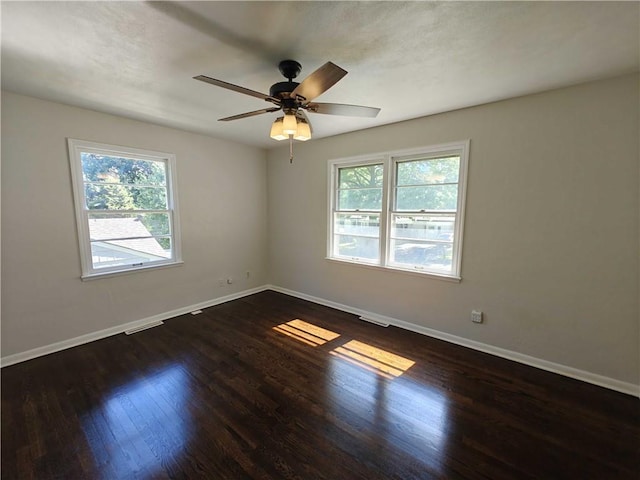 spare room with ceiling fan and dark hardwood / wood-style floors