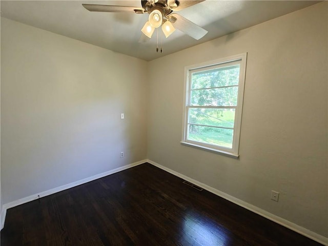 unfurnished room with dark hardwood / wood-style floors and ceiling fan