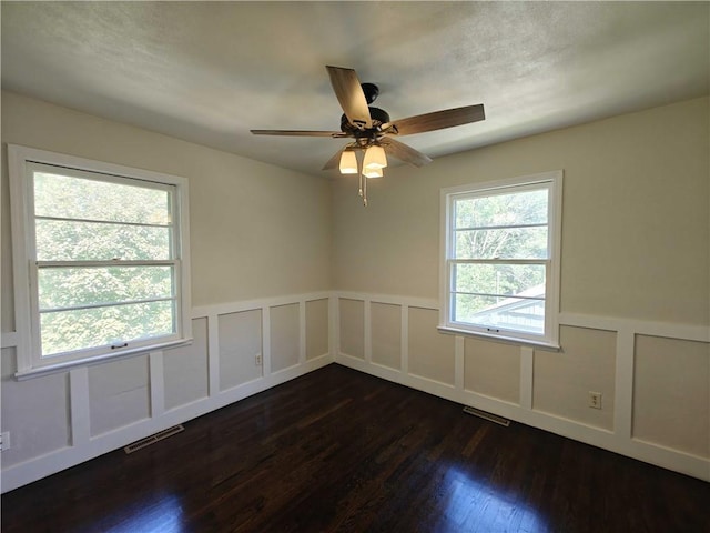 unfurnished room featuring dark hardwood / wood-style floors and ceiling fan